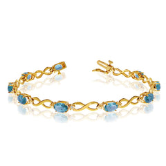 14K Yellow Gold Oval Blue Topaz Stones And Diamonds Infinity Tennis Bracelet, 7" - JewelryAffairs