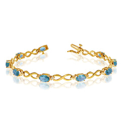 10K Yellow Gold Oval Blue Topaz Stones And Diamonds Infinity Tennis Bracelet, 7"